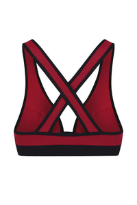 A flat lay image of the back view of a Davy J Sustainable Waterwear red bikini top with bold crossback design and black band