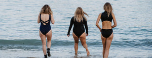 Three Girls wearing Davy J swimwear walking into the water to go wild swimming