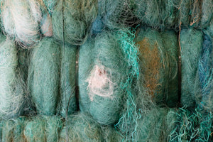 Bundles of ghost fishing nets ready for recycling to be made into Davy J sustainable swimwear